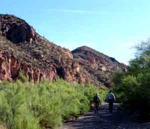 two people hiking in wash